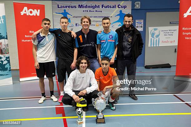 Edwin van der Sar poses with teams after the award ceremony for the Laureus Midnight Futsal Cup on December 11, 2011 in The Hague, Netherlands.