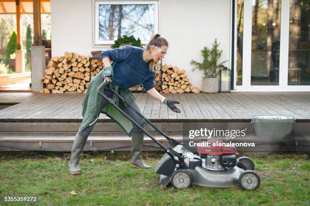 woman working in the garden ( lawn mower, breaking ) - mower stock pictures, royalty-free photos & images