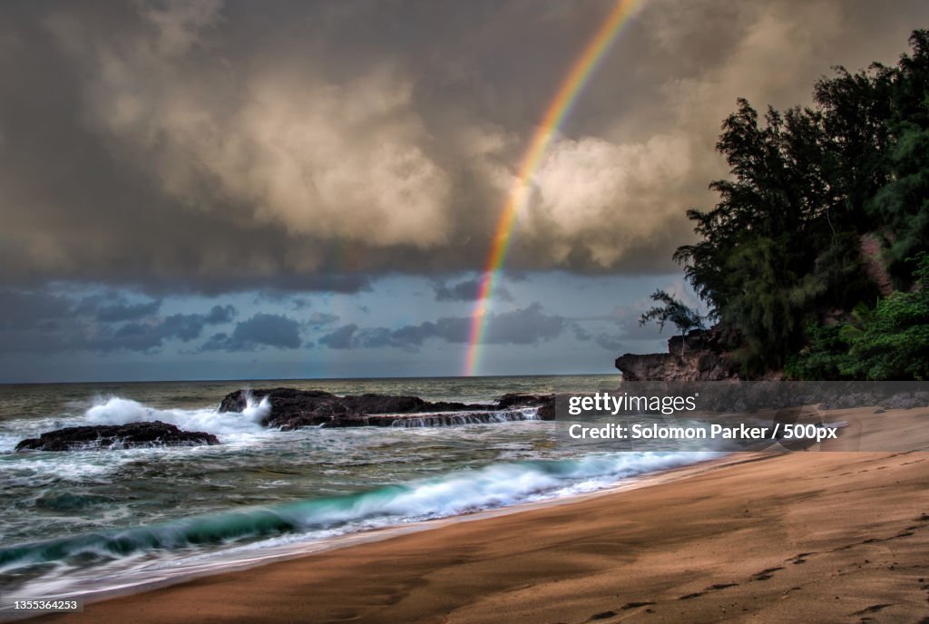 Scenic view of rainbow over sea against sky,Kauai County,Hawaii,United States,USA