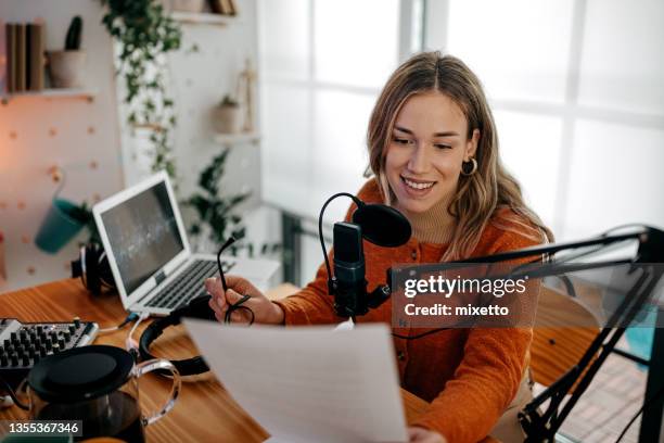 young woman recording podcast with paper - radio station stock pictures, royalty-free photos & images