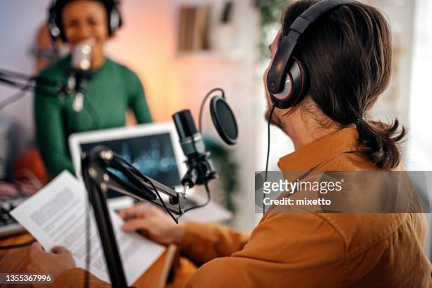 hombre y mujer jóvenes grabando podcast - equipo de grabación de sonido fotografías e imágenes de stock