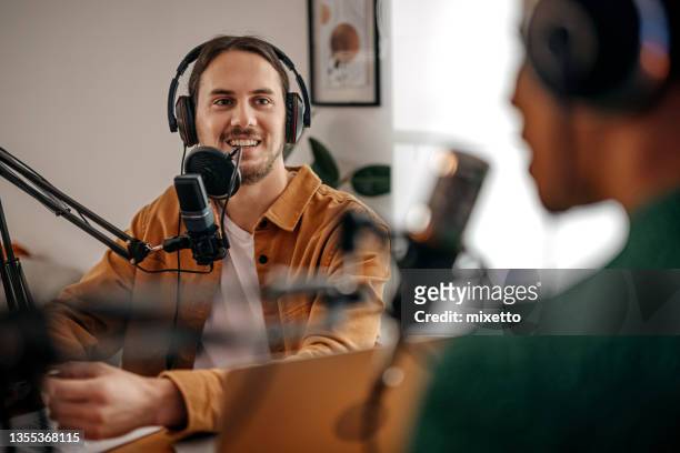 young man and woman recording podcast - radio host stock pictures, royalty-free photos & images