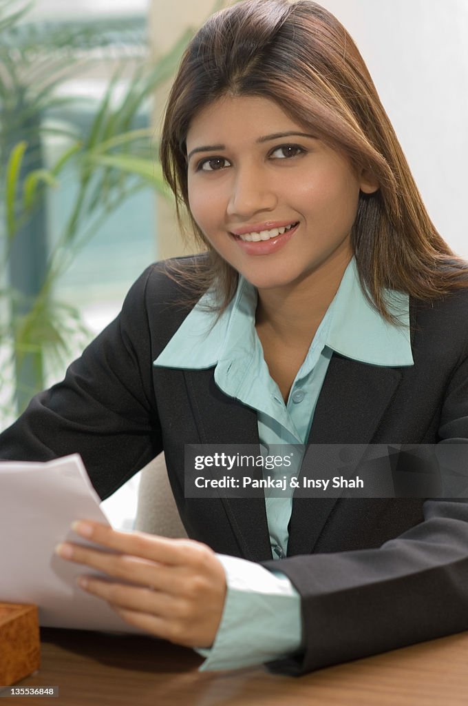 Businesswoman working in office,smiling,portrait