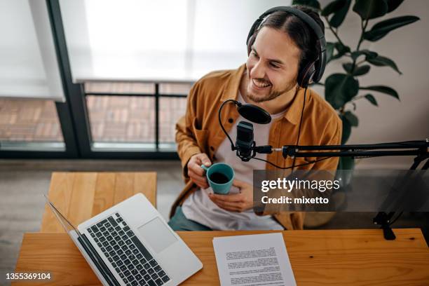 man drinking coffee and recording podcast - male presenter stock pictures, royalty-free photos & images