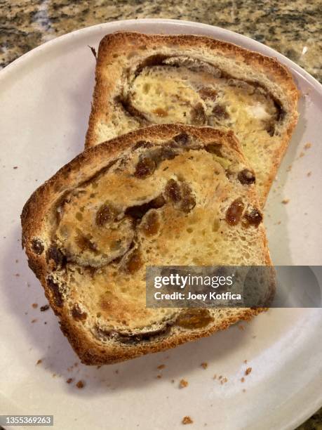 two slices of buttered toasted homemade cinnamon raisin bread - raisin toast stock pictures, royalty-free photos & images