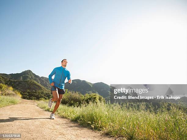 mixed race man running on remote trail - indio california fotografías e imágenes de stock