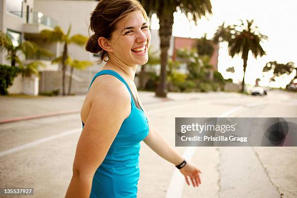 athletic mixed race woman crossing street - san diego street stockfoto's en -beelden