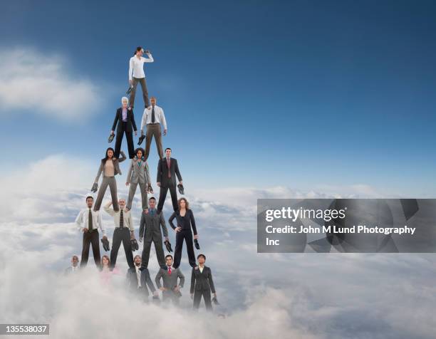 business people making a human pyramid - pyramids stock pictures, royalty-free photos & images