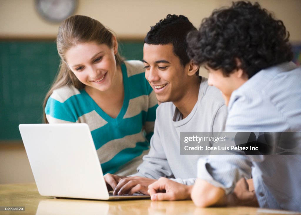 Teenager students using laptop together
