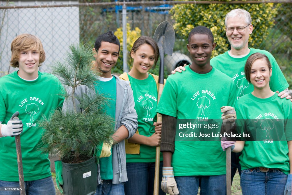 Volunteers planting a tree together