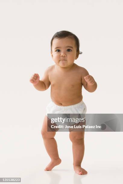 mixed race baby girl taking first steps - baby standing stock pictures, royalty-free photos & images