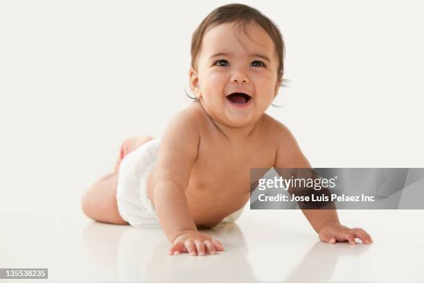 mixed race baby girl laying on floor - diaper girl stock pictures, royalty-free photos & images
