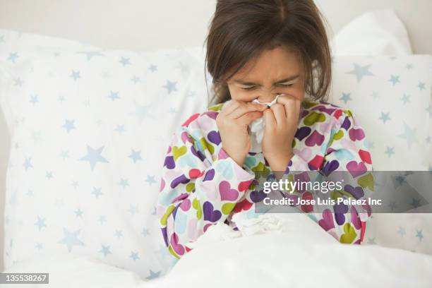 mixed race girl blowing nose - vulnerable children stock-fotos und bilder