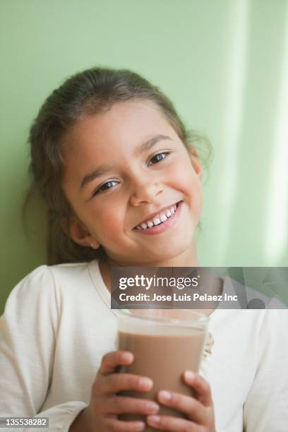 mixed race girl drinking chocolate milk - chocolate milk stock pictures, royalty-free photos & images