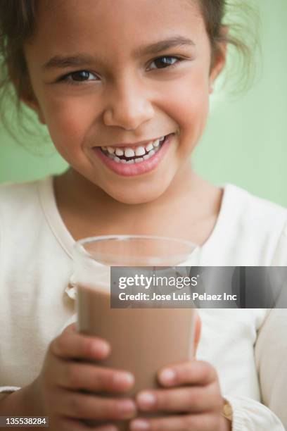 mixed race girl drinking chocolate milk - chocolate milk stock pictures, royalty-free photos & images