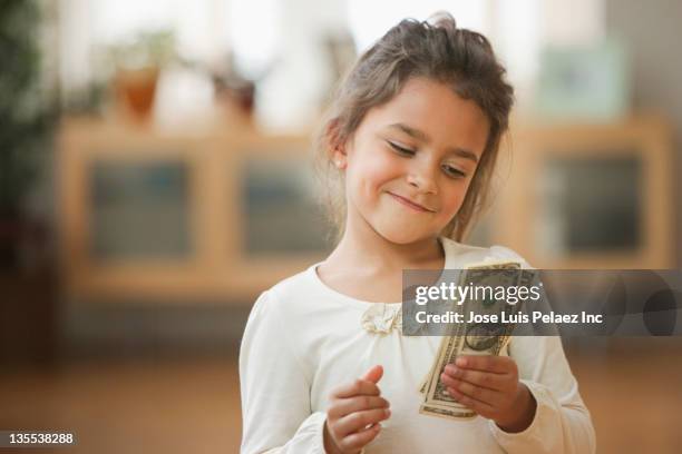 mixed race girl counting money - kids money fotografías e imágenes de stock