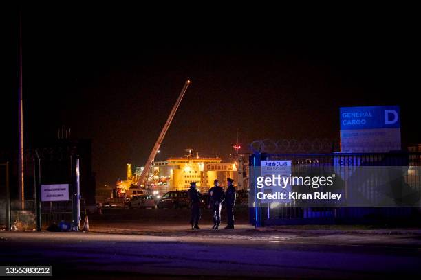 Police seal off the area around the rescue operation at Calais harbour on November 24, 2021 in Calais, France. At least 31 people including five...