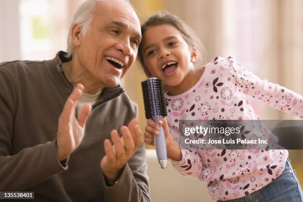 grandfather and granddaughter singing together - singing for kids stock pictures, royalty-free photos & images