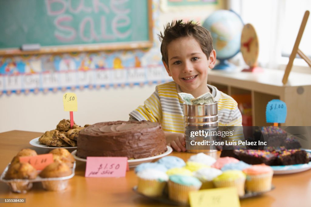 Caucasian boy looking at baked goods for sale