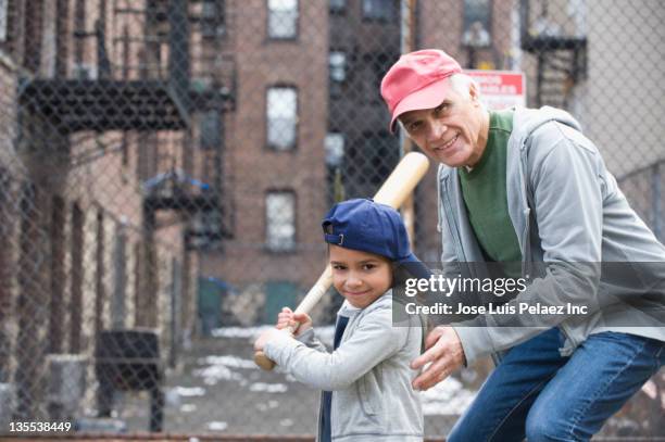 coach teaching girl to play baseball - girl baseball cap stock pictures, royalty-free photos & images