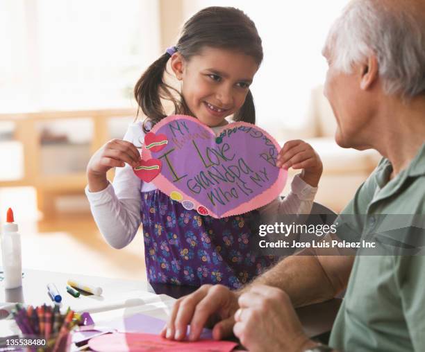 mixed race girl holding valentine for grandfather - homemade valentine stock pictures, royalty-free photos & images