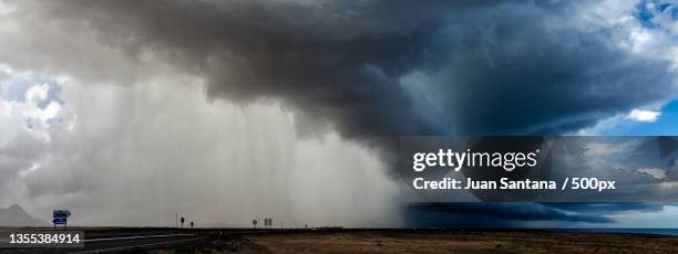 panoramic view of storm clouds over land,las palmas,spain - europa occidentale foto e immagini stock