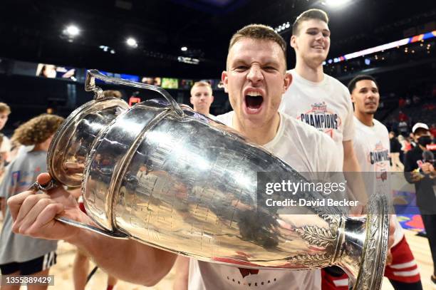 Brad Davison of the Wisconsin Badgers celebrates with the championship trophy after the team's victory over the St. Mary's Gaels in the championship...