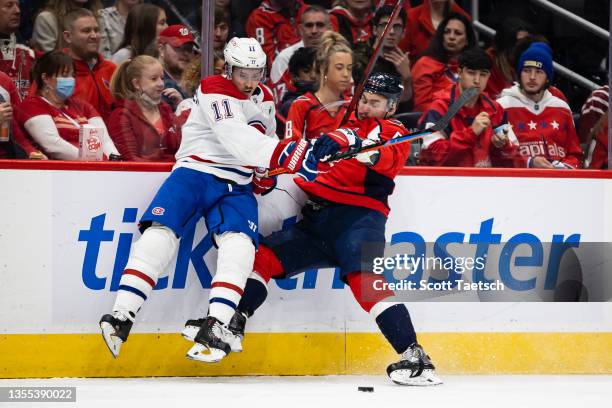 Brendan Gallagher of the Montreal Canadiens and Dmitry Orlov of the Washington Capitals battle for the puck during the first period of the game at...