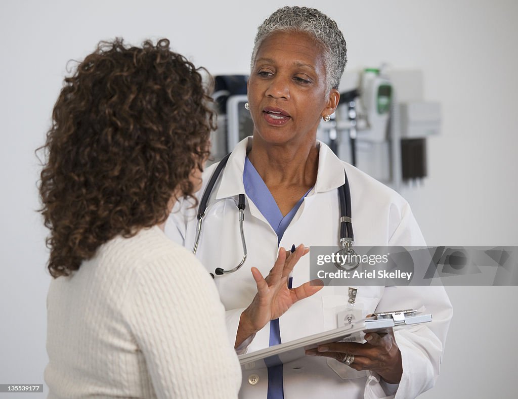 Doctor talking to patient in doctor's office