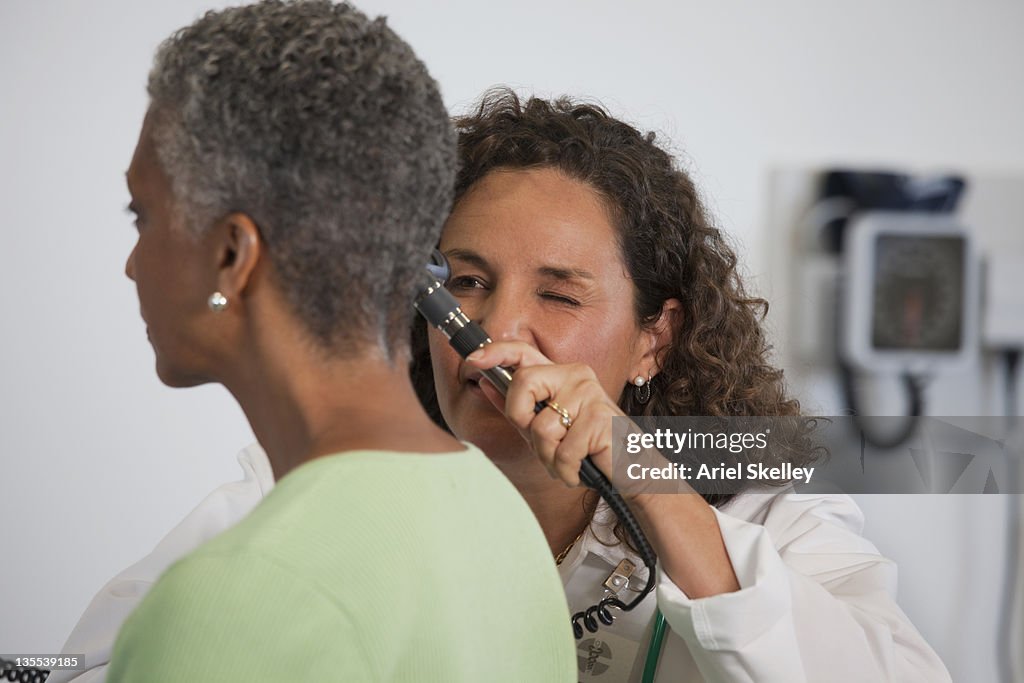 Doctor looking into patient's ear