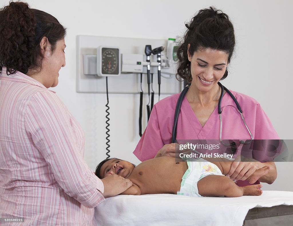 Doctor giving baby injection in doctor's office