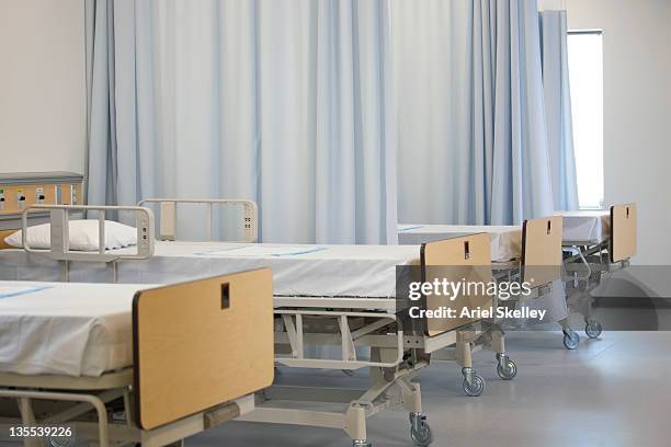 empty hospital beds in hospital - hospital bed curtains stock pictures, royalty-free photos & images