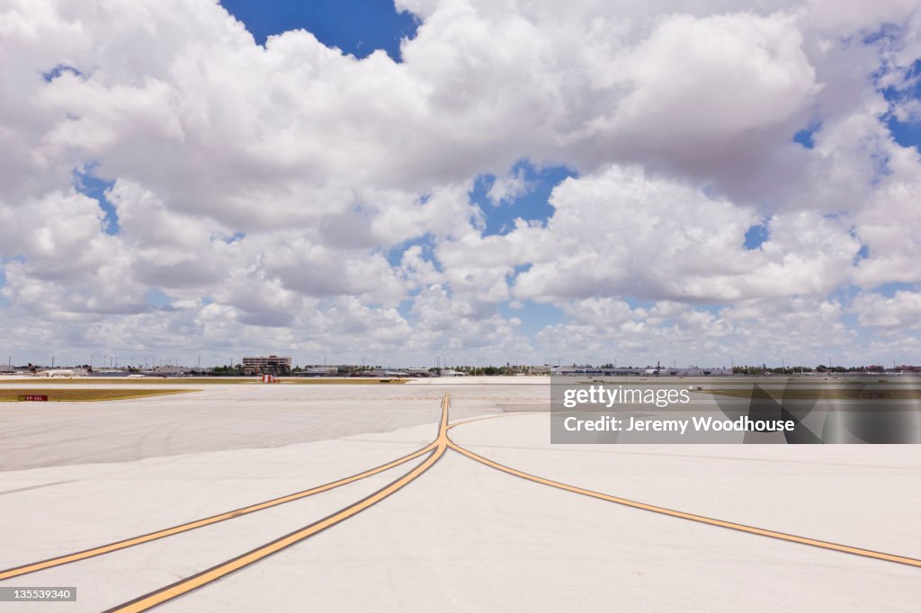 Airport tarmac and cloudy sky