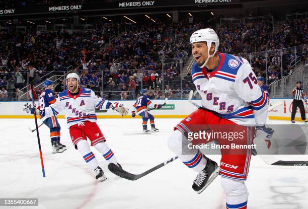 Barclay Goodrow and Ryan Reaves of the New York Rangers celebrate a third period goal by Kevin Rooney against the New York Islanders at the UBS Arena...