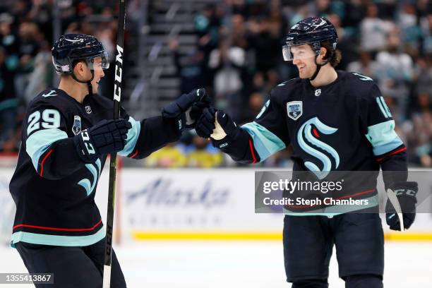 Vince Dunn celebrates with Jared McCann of the Seattle Kraken after McCann's goal during the second period against the Carolina Hurricanes at Climate...