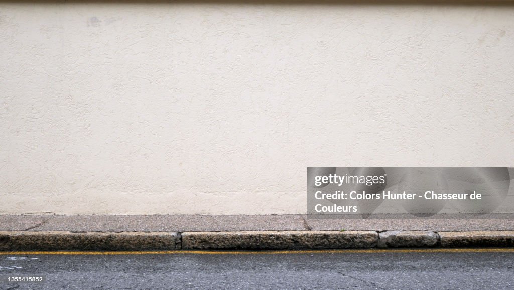 Empty and clean wall, sidewalk and street in Paris