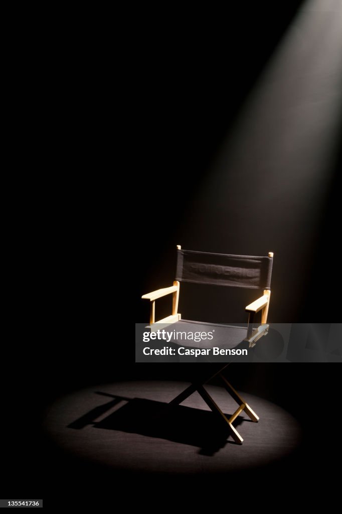 A spot lit directors chair