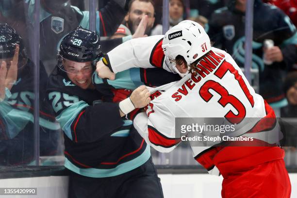 Vince Dunn of the Seattle Kraken is punched by Andrei Svechnikov of the Carolina Hurricanes during the third period at Climate Pledge Arena on...