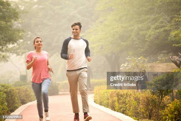 coppia sana che fa jogging nella natura - indian couple foto e immagini stock