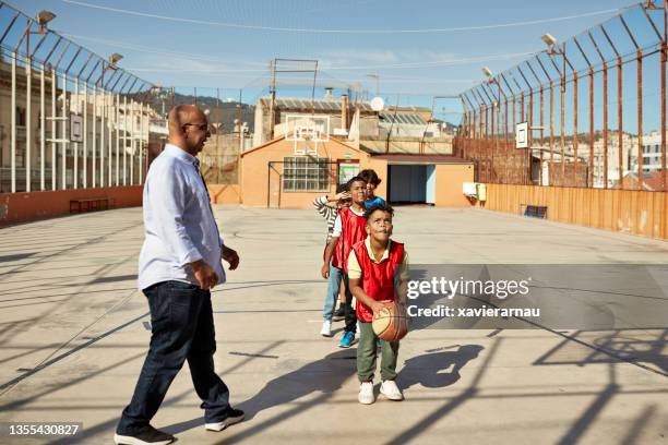 young schoolboy concentrating before shooting a free throw - school life balance stock pictures, royalty-free photos & images