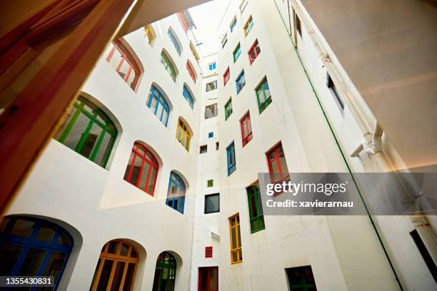 elementary school courtyard photographed through window - window frame exterior stock pictures, royalty-free photos & images