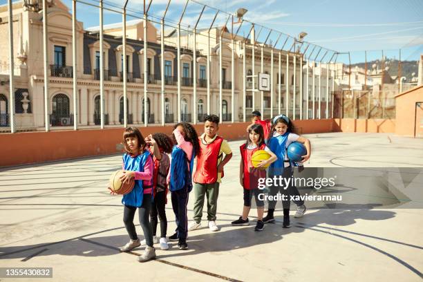 children waiting in line for a free throw during playtime - school life balance stock pictures, royalty-free photos & images