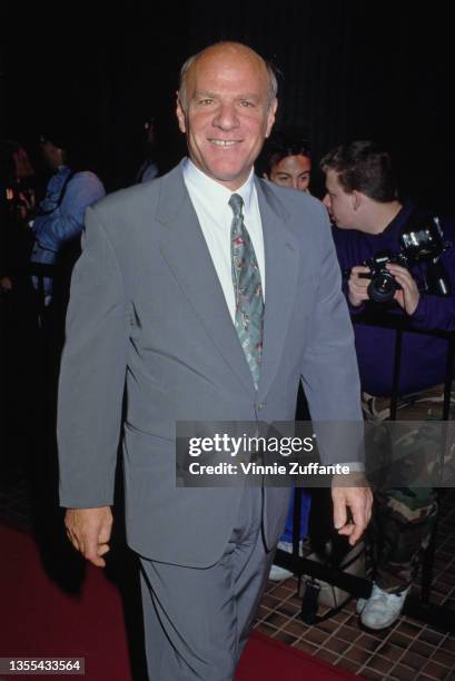 American businessman and broadcasting executive Barry Diller, Chairman of 20th Century Fox, wearing a grey suit, a white shirt and a blue-and-red...