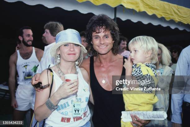 British actor and singer Michael Des Barres, wearing a black ves, with his wife, Pamela and son, Nicholas, backstage at the Live Aid benefit concert,...