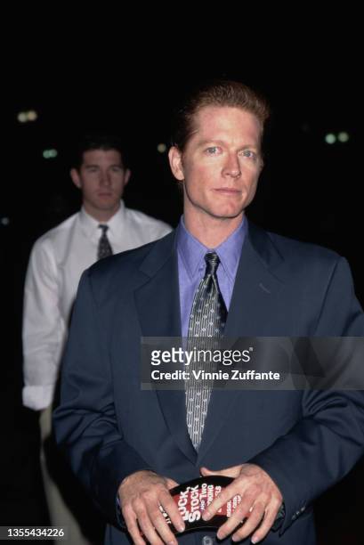 American actor Eric Stoltz, wearing a blue suit with a blue shirt and black spotted tie, attends the Culver City premiere of 'Lock Stock & Two...