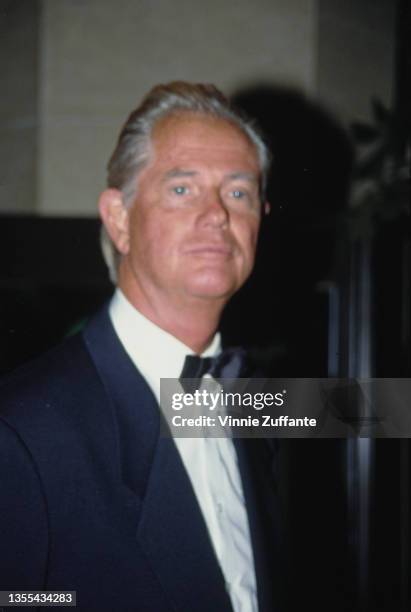 American actor and singer Troy Donahue wearing a dark blue tuxedo and bow tie, attending an event, circa 1995.