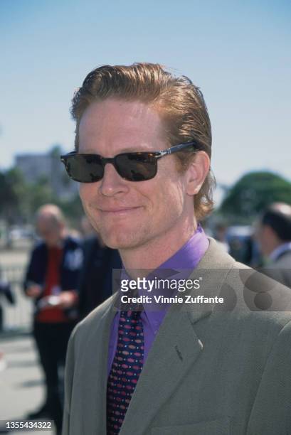 American actor Eric Stoltz, wearing a grey jacket, a purple shirt, a necktie and sunglasses, attends the 14th Independent Spirit Awards, held at...
