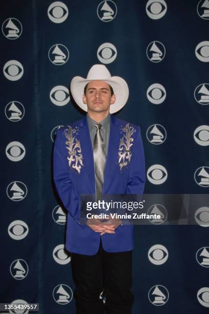 American singer and songwriter Brad Paisley, wearing a blue jacket over a grey shirt with a silver tie and a white cowboy hat, attends the 42nd...