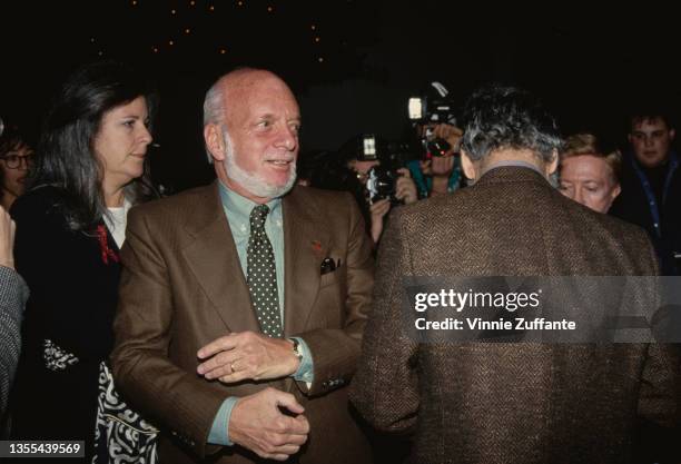 American theatrical director and producer Hal Prince , wearing a brown blazer and a green shirt with a spotted tie, and American composer and...