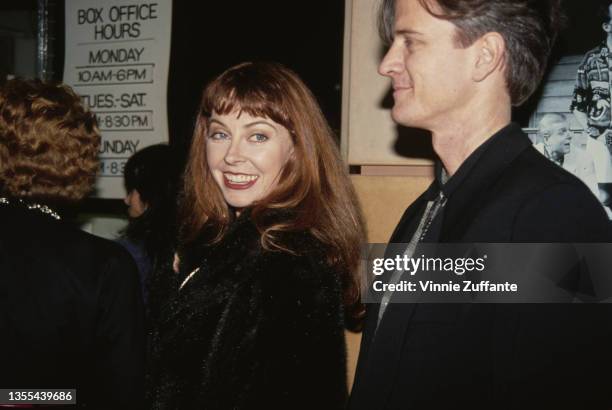American actress Cassandra Peterson with a man attends an theatrical production venue, United States, circa 1995. Peterson is best known for playing...